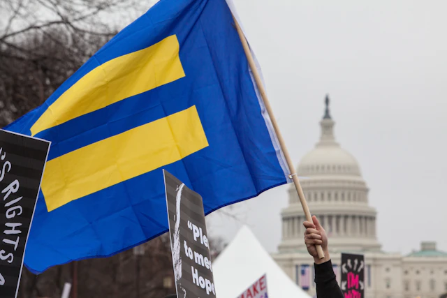 HRC flag with blue background and yellow equal sign flies in front of U.S. Capitol
